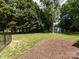 This spacious backyard features a lawn and a storage shed at 6922 Woodstock Dr, Charlotte, NC 28210