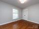 Cozy bedroom with hardwood floors, natural light, and a closet for storage at 6922 Woodstock Dr, Charlotte, NC 28210