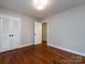 Inviting bedroom featuring hardwood floors, natural light, and closet at 6922 Woodstock Dr, Charlotte, NC 28210