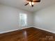 Charming bedroom boasts pristine walls, beautiful hardwood floors, and abundant natural light at 6922 Woodstock Dr, Charlotte, NC 28210
