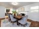 Charming dining room with fireplace, dark wood table, and gray upholstered chairs, open to the modern kitchen at 6922 Woodstock Dr, Charlotte, NC 28210