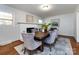 Cozy dining room with a fireplace, modern decor, and a stylish rug under the wooden table and velvet chairs at 6922 Woodstock Dr, Charlotte, NC 28210