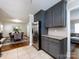 Open kitchen design showcasing granite countertops, stainless steel fridge, and a view into the dining area at 6922 Woodstock Dr, Charlotte, NC 28210
