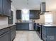 Well-lit kitchen features stainless steel appliances, granite countertops, and sleek gray cabinetry at 6922 Woodstock Dr, Charlotte, NC 28210