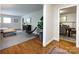 Open-concept layout showing the living room and dining area featuring hardwood floors at 6922 Woodstock Dr, Charlotte, NC 28210