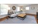 Cozy living room featuring a sectional sofa, plush cushions, and natural light from large windows at 6922 Woodstock Dr, Charlotte, NC 28210