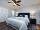 Comfortable main bedroom with a large bed, stylish rug, and ample natural light at 6922 Woodstock Dr, Charlotte, NC 28210