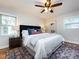 Beautiful main bedroom features a plush bed, side tables, and a patterned rug at 6922 Woodstock Dr, Charlotte, NC 28210