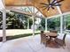 Covered patio with a wooden ceiling, ceiling fan, and expansive backyard at 6922 Woodstock Dr, Charlotte, NC 28210