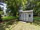 Backyard storage shed with double doors and two windows at 6922 Woodstock Dr, Charlotte, NC 28210