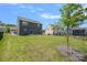 Exterior view of the home’s backyard with green grass and modern neighboring homes at 699 Kitfox Nw Dr, Concord, NC 28027