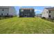 Exterior view of the home’s backyard with green grass and a modern fence at 699 Kitfox Nw Dr, Concord, NC 28027