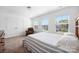 Bright bedroom featuring three windows, double closets, and a comfortable striped bed at 699 Kitfox Nw Dr, Concord, NC 28027