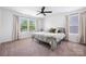Bright bedroom features a metal bed frame, ceiling fan, and lots of natural light at 699 Kitfox Nw Dr, Concord, NC 28027