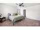 The primary bedroom includes a ceiling fan and neutral decor, with carpeted floors at 699 Kitfox Nw Dr, Concord, NC 28027