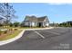 Exterior view of a modern community center with ample parking at 699 Kitfox Nw Dr, Concord, NC 28027