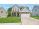 Charming two-story home with a well-manicured lawn, stone accents, and a two-car garage, offering great curb appeal at 699 Kitfox Nw Dr, Concord, NC 28027
