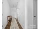 Bright hallway with a patterned runner and white walls, leading to the main living areas of the home at 699 Kitfox Nw Dr, Concord, NC 28027