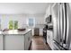 Open kitchen with stainless steel appliances, granite countertops, and a kitchen island flowing into a dining area and backyard access at 699 Kitfox Nw Dr, Concord, NC 28027