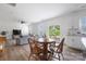Bright and open living space with hardwood floors, a ceiling fan, and large windows overlooking the backyard at 699 Kitfox Nw Dr, Concord, NC 28027