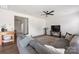 Spacious living room showcasing a large gray sectional sofa and open floor plan at 699 Kitfox Nw Dr, Concord, NC 28027