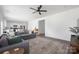 Open concept living room with kitchen and dining area featuring a large sectional sofa at 699 Kitfox Nw Dr, Concord, NC 28027