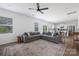 Open concept living room and kitchen area featuring a large gray sectional sofa at 699 Kitfox Nw Dr, Concord, NC 28027