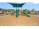 Community playground featuring slides, swings, and a shaded canopy in a Gathering-friendly neighborhood at 699 Kitfox Nw Dr, Concord, NC 28027