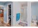 Bathroom with tile shower and glass door, toilet, and wood-look flooring at 734 Club Dr, Statesville, NC 28677