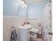 Bathroom featuring white tile, vanity sink, commode, and mirrored lighting at 734 Club Dr, Statesville, NC 28677
