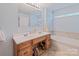 Bright bathroom featuring a double vanity, tile floors, and a soaking tub at 734 Club Dr, Statesville, NC 28677