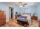 Comfortable bedroom with hardwood floors, a ceiling fan, and ample closet space at 734 Club Dr, Statesville, NC 28677