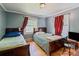 Bedroom with two beds, wood floors, blue walls and red curtains at 734 Club Dr, Statesville, NC 28677