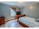Bedroom with wood floors, blue walls, and a window view at 734 Club Dr, Statesville, NC 28677