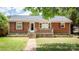 Charming single-story brick home with a stone foundation and inviting front porch at 734 Club Dr, Statesville, NC 28677