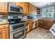 Functional kitchen with stainless steel appliances and warm wood cabinetry at 734 Club Dr, Statesville, NC 28677