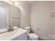 Bright bathroom features a modern sink, vanity, mirror, and toilet at 8221 Pineville Matthews Rd # G, Charlotte, NC 28226