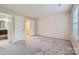 Spacious bedroom with two windows, neutral paint, carpet, and bathroom entrance at 8221 Pineville Matthews Rd # G, Charlotte, NC 28226