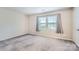 Neutral bedroom with curtains and carpet at 8221 Pineville Matthews Rd # G, Charlotte, NC 28226