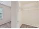 Walk-in closet with shelving, neutral paint, carpet, and window at 8221 Pineville Matthews Rd # G, Charlotte, NC 28226