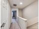 Bright upstairs hallway with carpeted floors and neutral paint leading to the bedrooms at 8221 Pineville Matthews Rd # G, Charlotte, NC 28226