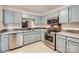 Functional kitchen design with stainless steel appliances, updated countertops, and ample cabinet space at 8221 Pineville Matthews Rd # G, Charlotte, NC 28226