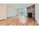 Spacious living room featuring a stone fireplace and hardwood floors at 8221 Pineville Matthews Rd # G, Charlotte, NC 28226