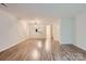 Spacious living room featuring modern wood-look flooring and neutral paint at 8221 Pineville Matthews Rd # G, Charlotte, NC 28226