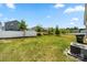 Large, grassy backyard enclosed by a white fence, offering privacy and space for outdoor activities at 9037 Remnick Dr, Gastonia, NC 28056