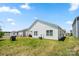 Well-maintained backyard with a spacious lawn and white vinyl siding on the home at 9037 Remnick Dr, Gastonia, NC 28056