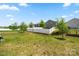 Large, well-maintained backyard with a white fence and young trees at 9037 Remnick Dr, Gastonia, NC 28056