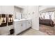 Bathroom featuring double sinks, a large mirror, and a view into a bedroom at 9037 Remnick Dr, Gastonia, NC 28056
