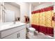 Bright bathroom featuring a white vanity, framed mirror, and a shower with a patterned curtain at 9037 Remnick Dr, Gastonia, NC 28056