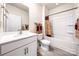 Well-lit bathroom featuring a shower-tub combination with tile surround and a vanity with solid surface countertop at 9037 Remnick Dr, Gastonia, NC 28056